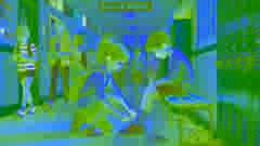Talia helps Marco tie his shoes in a school hallway.