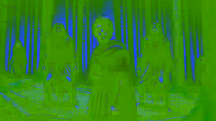 Evander stands protectively before Lycaon in a dimly lit forest as the Erinyes approach, their eyes glowing with fury.