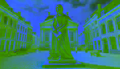  A bronze statue of Lady Elise stands in a modern Leeuwarden city square, holding a letter as people pass by, acknowledging her legacy.