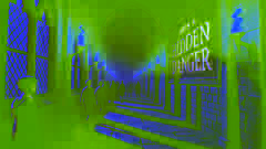A dark corridor in a magical school with a red message on the wall, creating an eerie atmosphere.
