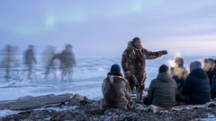 Elder recounting Adlet origins near Hudson Bay with images of running dog-legs