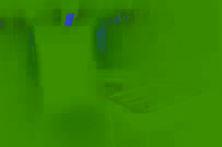 A dim hallway in a run-down building, with surgical tools on a desk behind a swinging door