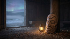 cedar mask carved with two-headed Sisiutl motif resting near carved house posts